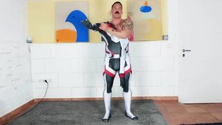 Muscle boy attempts on latex costume play suit with the help of his muscle Parent